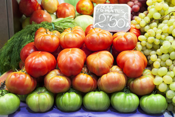 Tomatoes and grapes at fruit market.