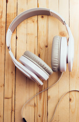 White headphones on a wooden background