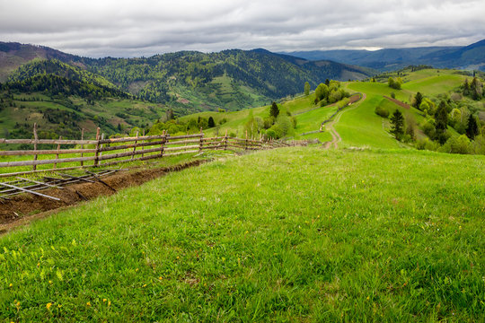 fence on hillside meadow in mountain