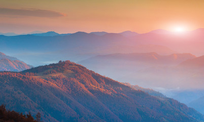 Panorama of autumn mountains in the morning mist