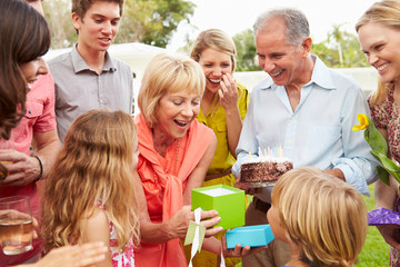 Multi Generation Family Celebrating Birthday In Garden