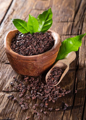 Cocoa pod with bowl on a dark wooden table.