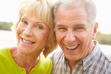 Head And Shoulders Portrait Of Senior Couple Outdoors