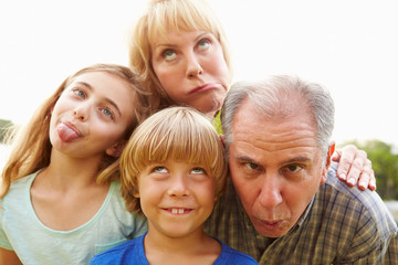 Fototapeta na wymiar Grandparents And Grandchildren Pulling Funny Faces