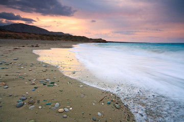 Cloudy winter sunset on a beach in Crete, Greece.
