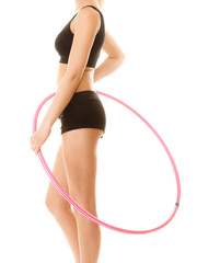 sporty fit girl doing exercise with hula hoop.