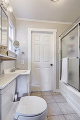 Fototapeta na wymiar White bathroom with glass door shower