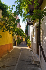 Fototapeta na wymiar Narrow street at old medieval city and harbor Rethymno, Crete