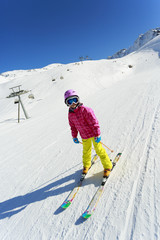 Skiing, skier on ski run - child skiing downhill