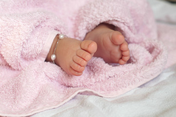Close-up of  Baby feet under blanket