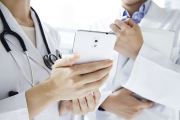 Doctor looking at the mobile phone