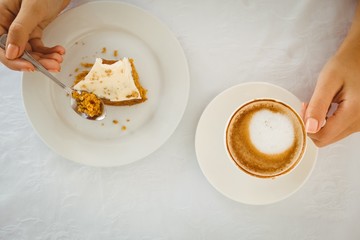 Woman having cake and coffee