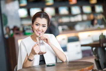 Beautiful woman drinking sweet drink in Cafe