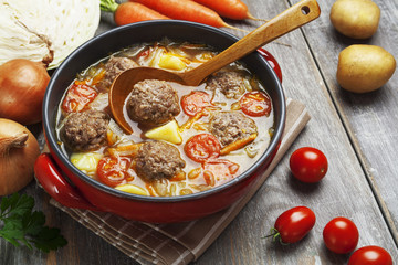 Cabbage soup with meatballs and tomatoes