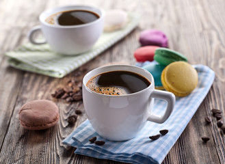 Cup of coffee and french macaron.