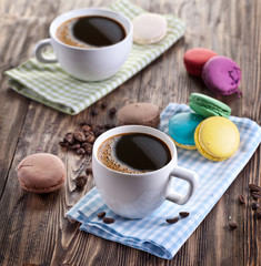 Cup of coffee and french macaron.