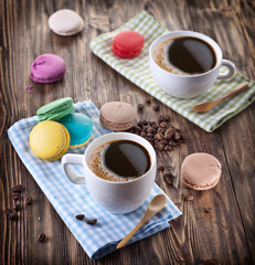 Cup of coffee and french macaron.