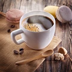 Cup of coffee and french macaron.