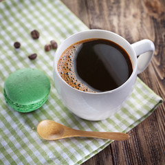 Cup of coffee and french macaron.