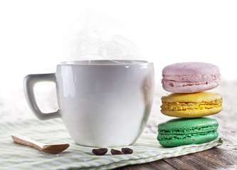 Cup of coffee and french macaron.