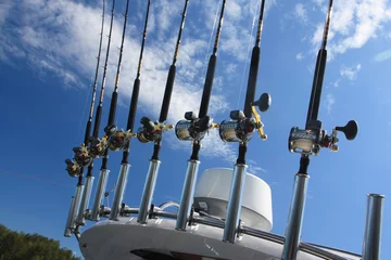 Fotobehang Spinning rods on the frame of the fishing boats © okyela