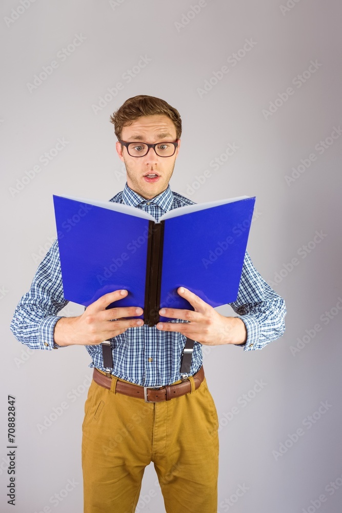 Poster geeky businessman reading a book