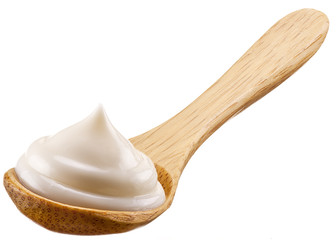 Handful of mayonnaise in wooden spoon.