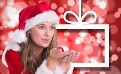 Composite image of festive blonde blowing over hands