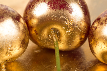 Gold fruits close up on gold background 