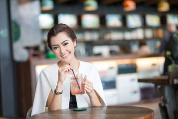 Beautiful woman drinking sweet drink in Cafe