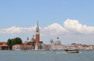 Bell tower of Saint George in the venetian lagoon and the boat