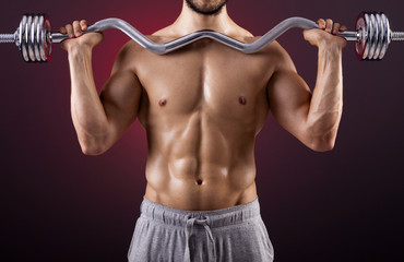 Fitness man lifting weights with curl bar
