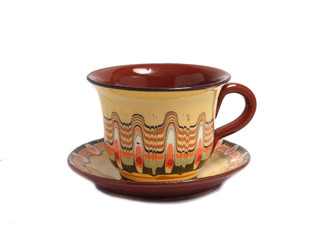 a small cup of tea with a plate under it