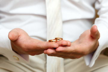 Gold wedding rings on a hand of the groom