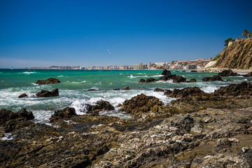Sea rocks with skyline of fuengirola spain.