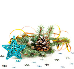 Christmas tree branch with gold serpentine and star on white bac