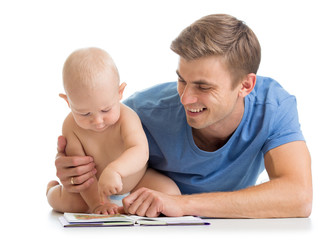 father reading a book to son baby