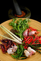 Asian herbs, spices and vegetables with mortar making curry