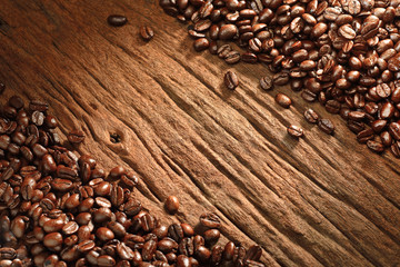 Top view of coffee beans on old wooden background