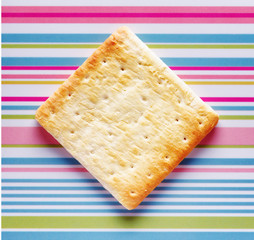 Yellow biscuits on striped background