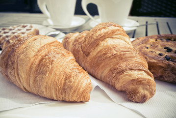 coffee and croissants on table