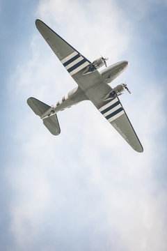 vintage propeller aircraft against a blue sky
