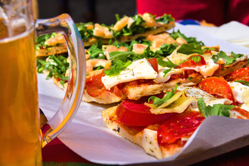 Italian appetizers and mug of beer in a restaurant