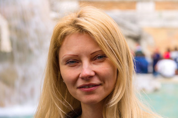 Urban portrait of attractive girl on background of the fountain