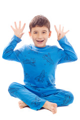 Naughty boy in pajamas on white background