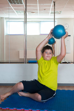 Boy does exercise with the ball
