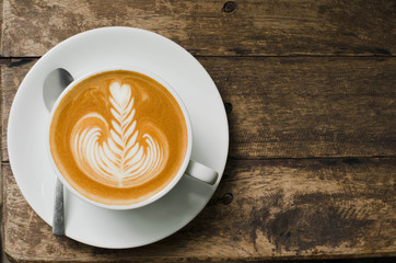 classic foamy cappuccino on dark grained wood table from above - obrazy, fototapety, plakaty