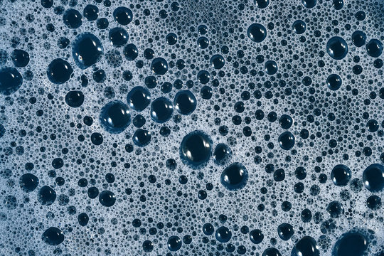 Soapsuds bubbles as background.