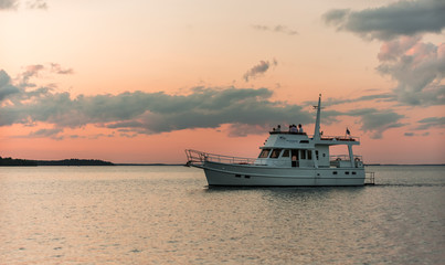 Fototapeta na wymiar White ship at sunset