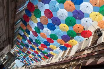 Street decorated with colored umbrellas oblique view